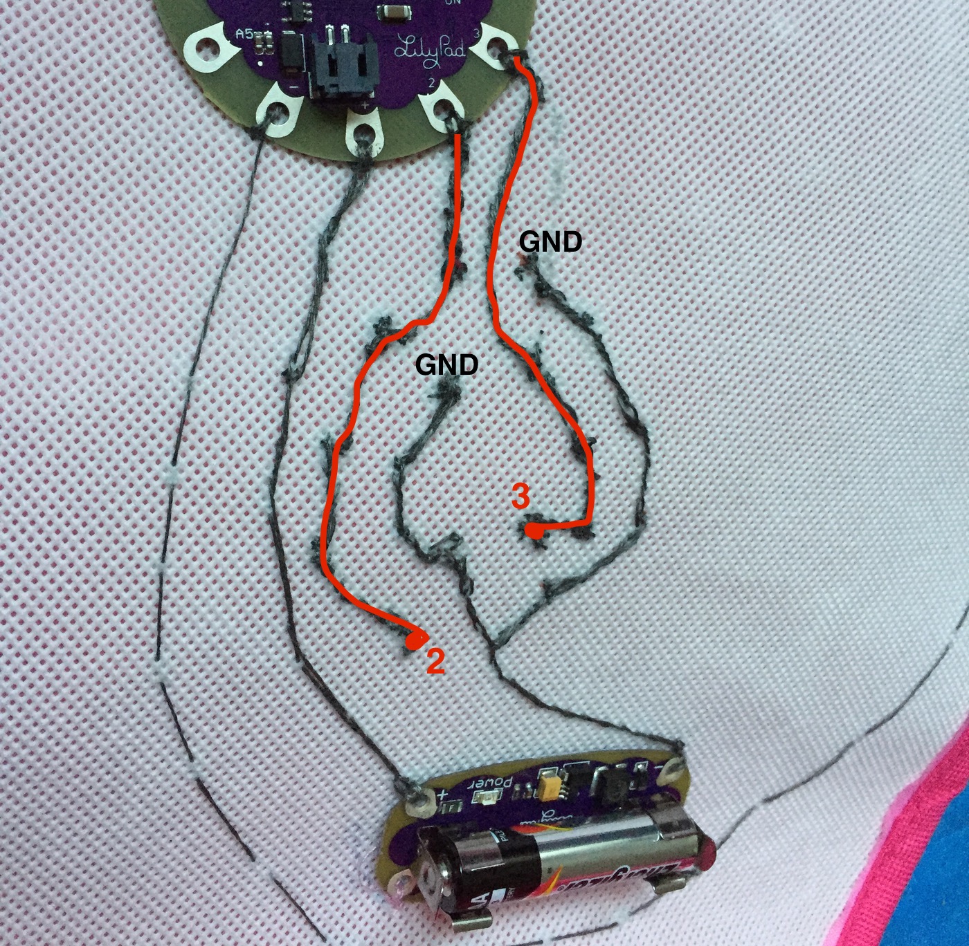 All circuits sewn into place, with terminals 2 and 3 providing positive signal, and a GND wire which forks into two paths.