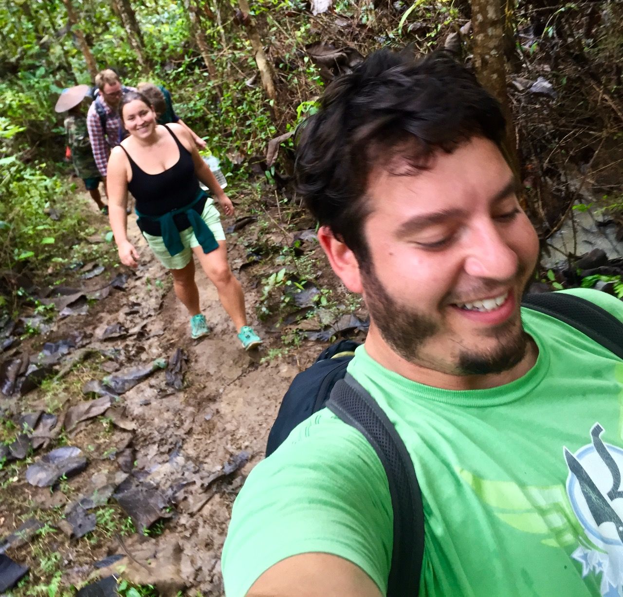 Happy people walking down a jungle trail.