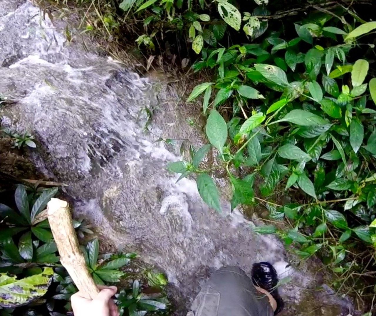 First-person view of a hiker in a waterfall.
