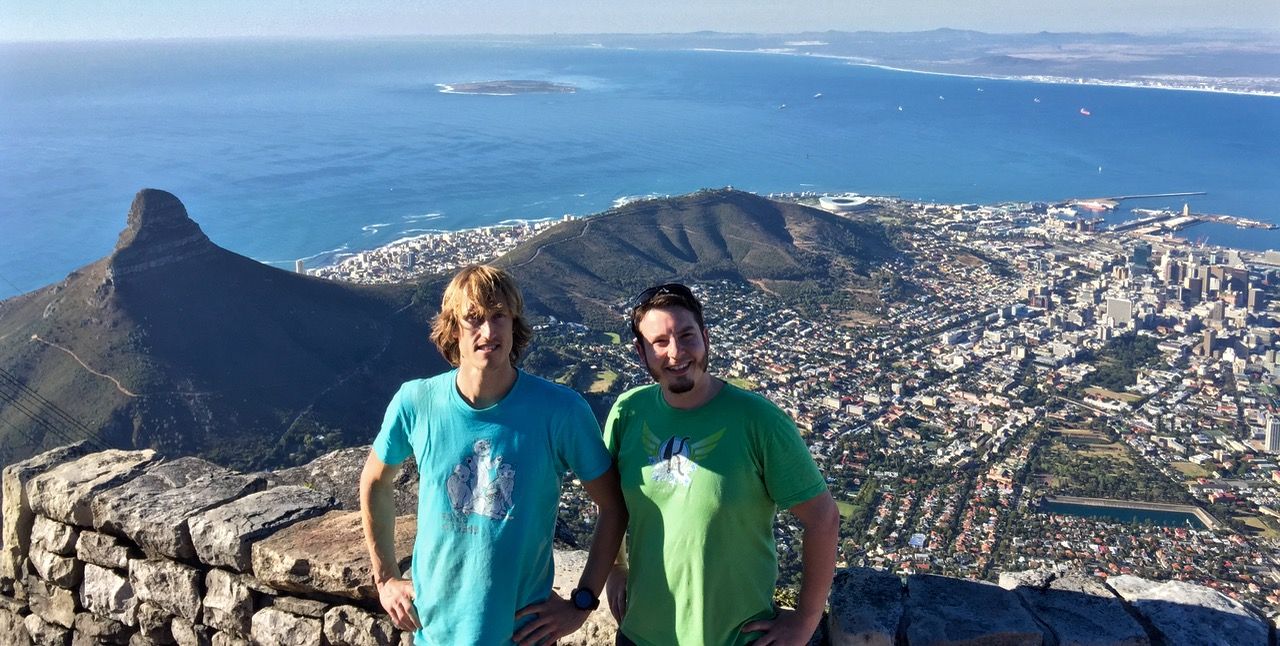 Mark and Chris standing on Table Mountain with Capetown behind them.