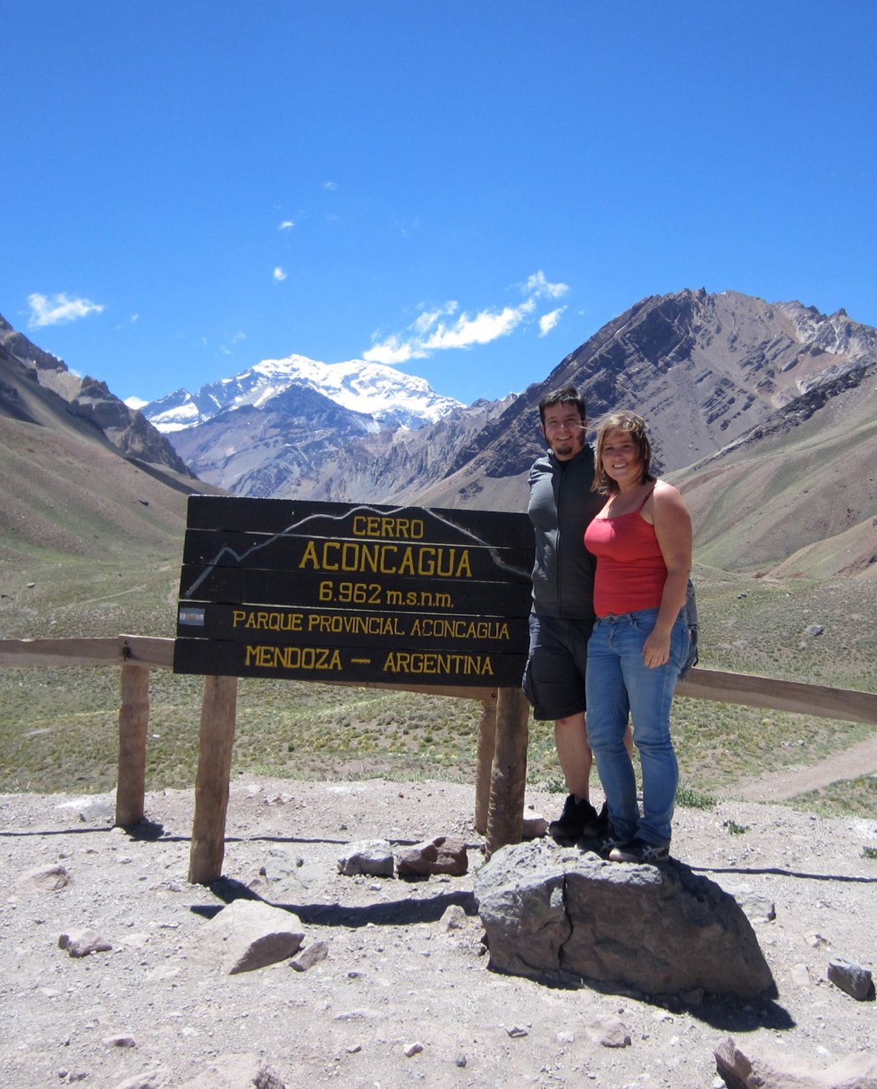 Karin and I standing in front of a sign for Cerro Aconcagua.