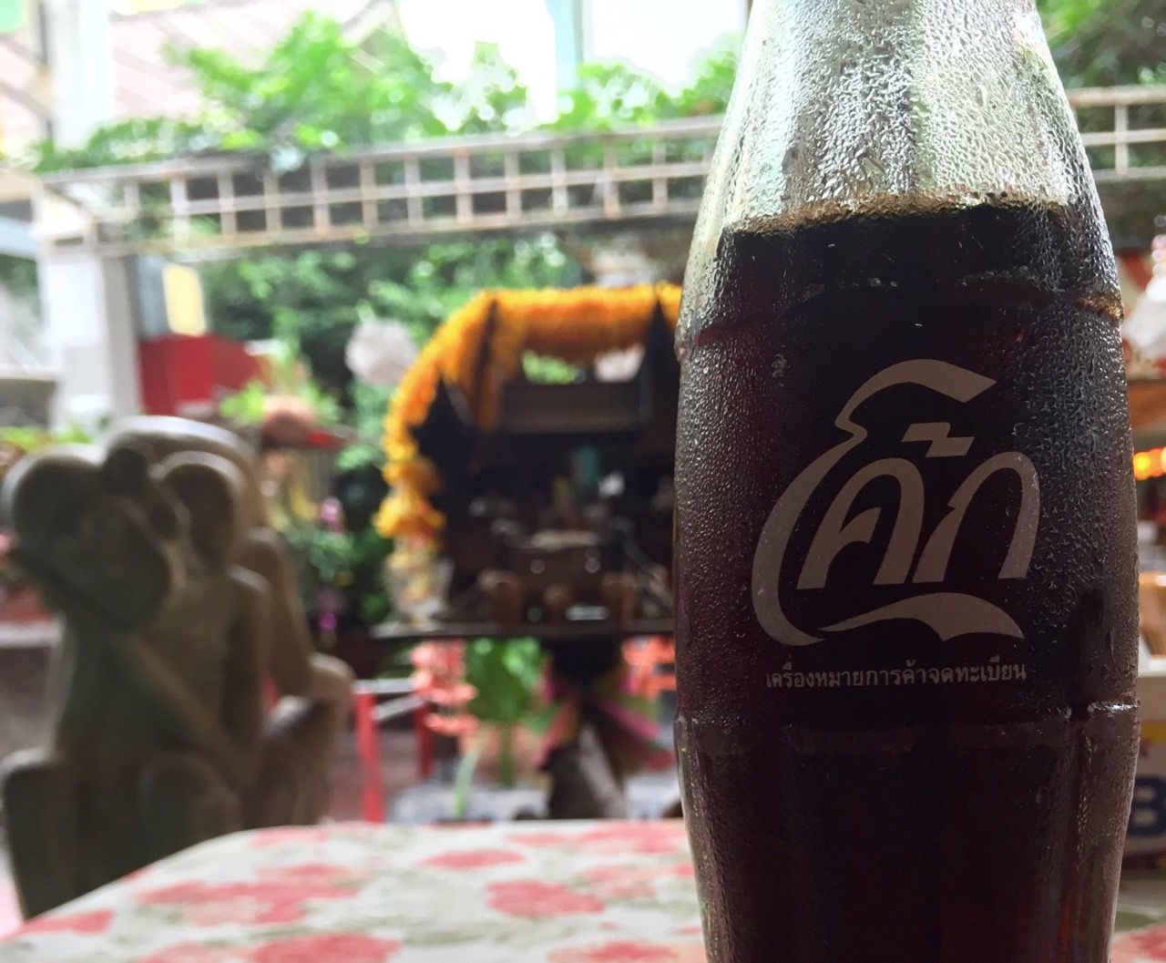 A bottle of Coca-Cola with a thai label.