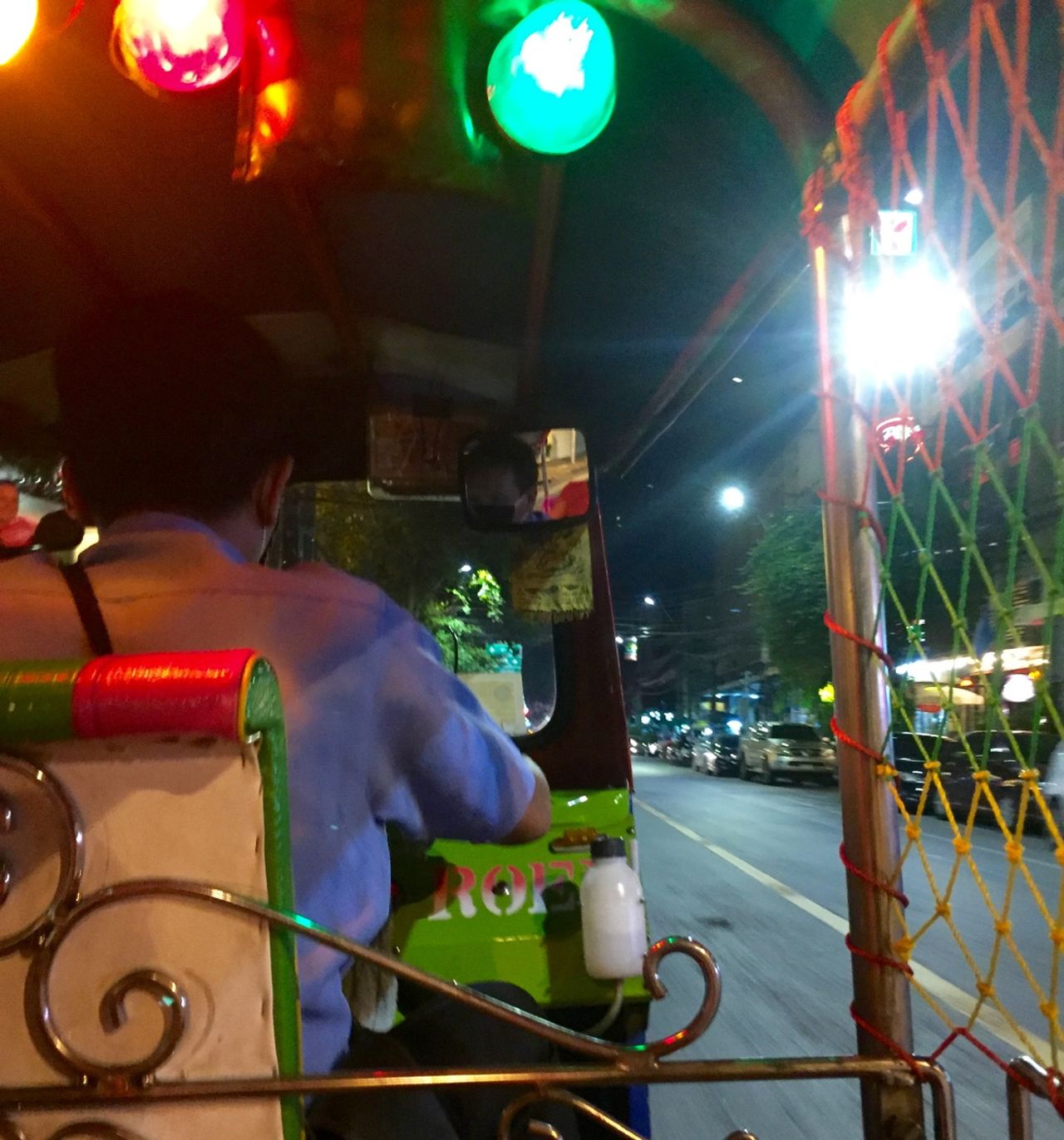 Riding in the back of a tuk tuk.