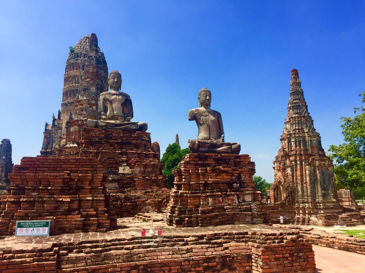 Temple ruins featuring large statues of Buddha.