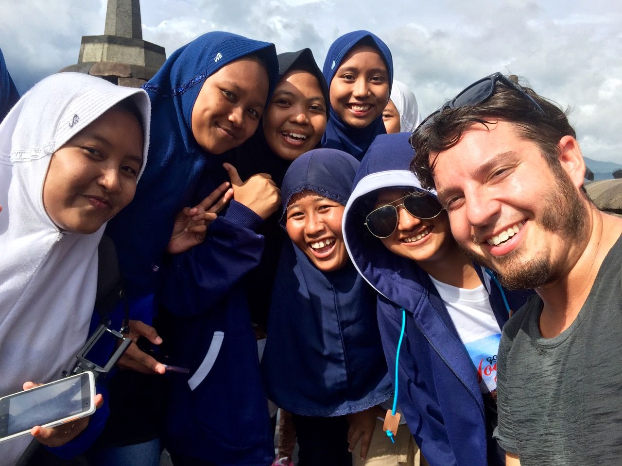 Man posing with Indonesian girls.