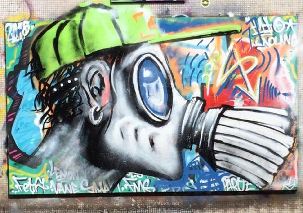 Graffiti of a man wearing a gas mask.
