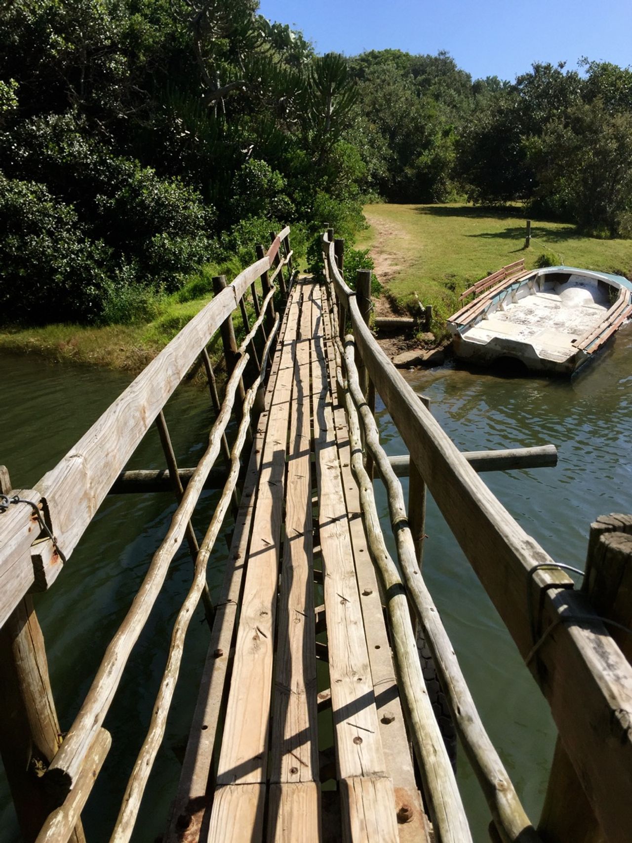Wooden bridge leading to land.