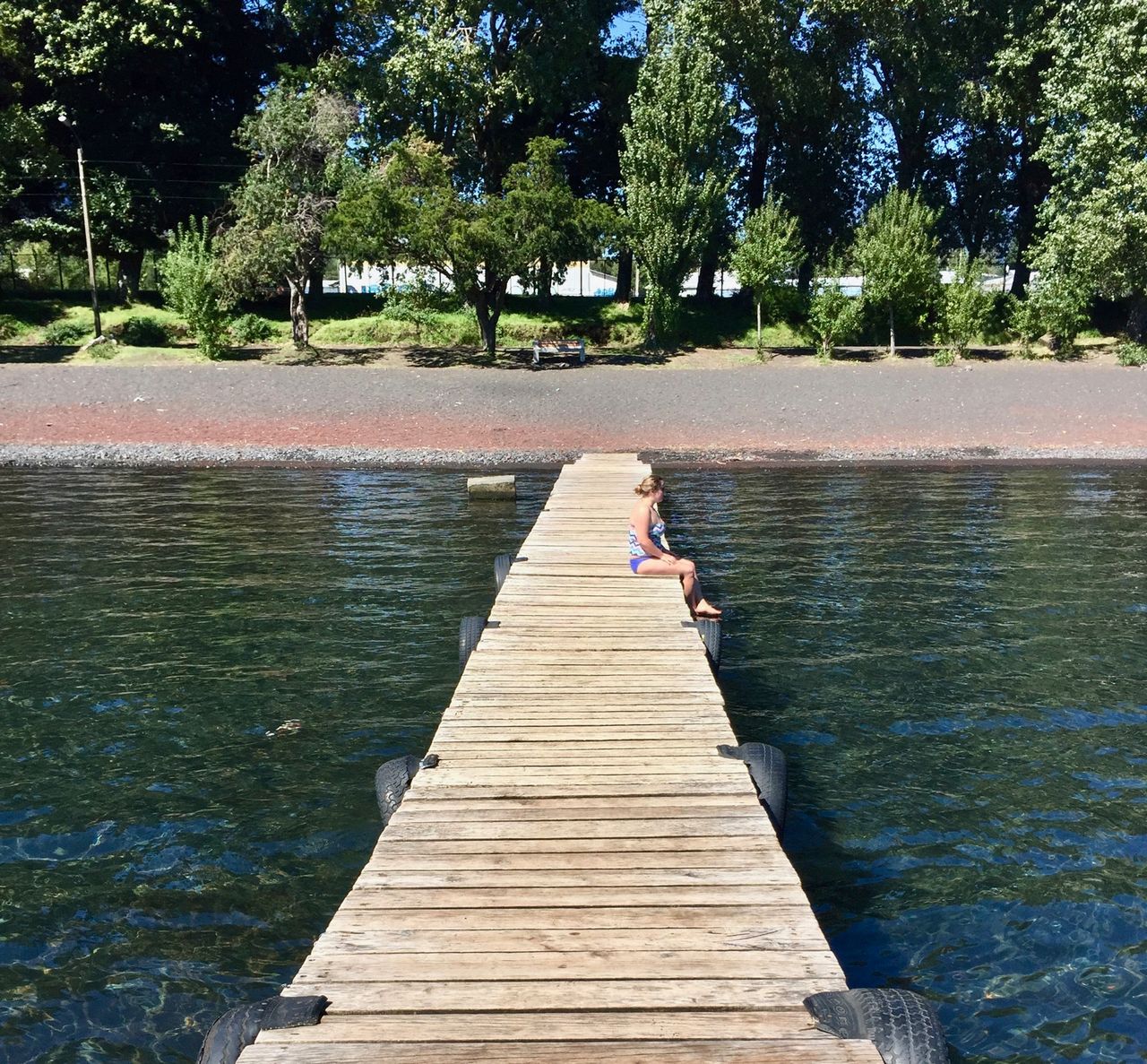 Woman sitting on a dock.