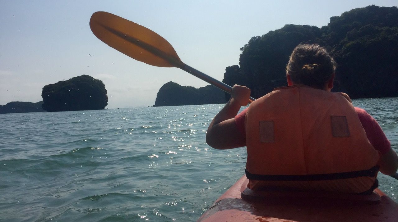 Woman paddling in a kayak.