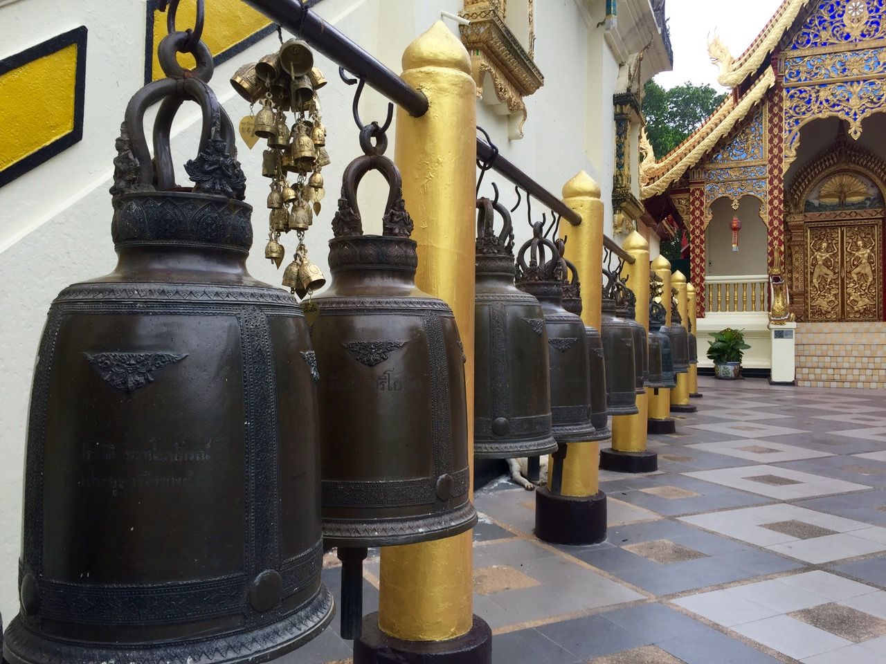 A line of bells with black and gold adornment.