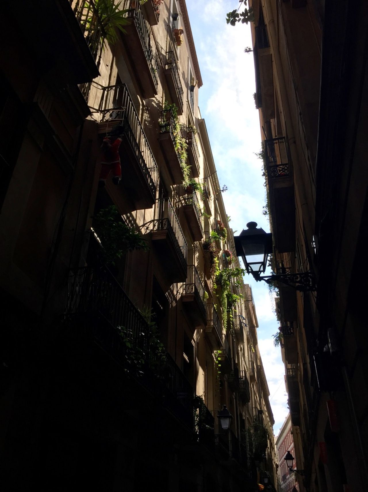 Looking upward at balconies in a narrow alley