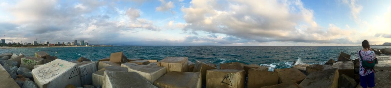 Panoramic of the Mediterranean sea from a stone dock.