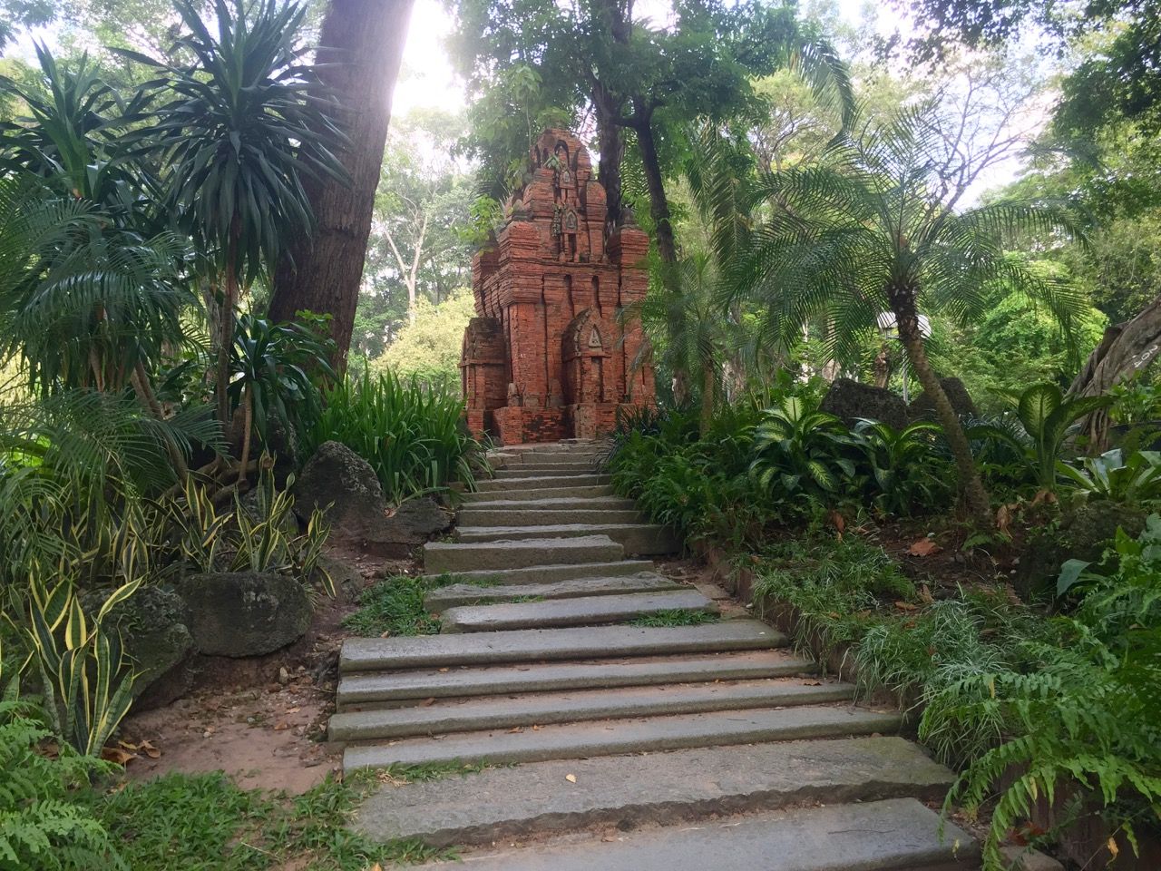 A stone temple in a park.