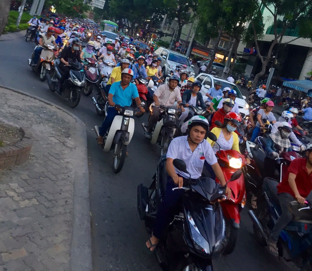 A street filled with thousands of motorbikes during rush hour.