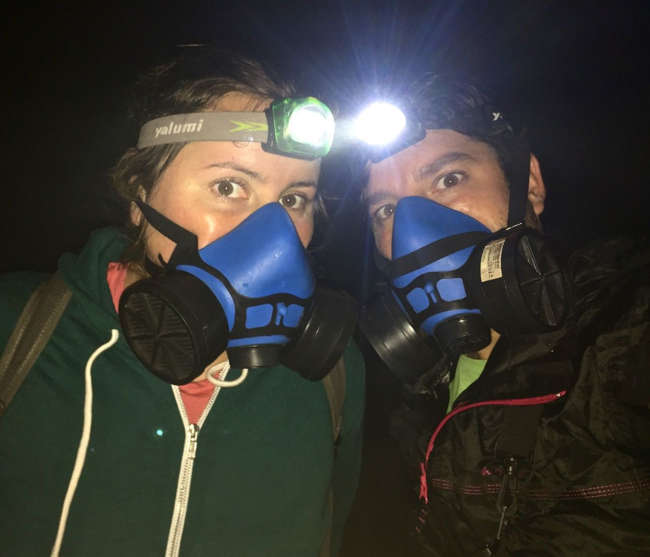 Two people wearing gas masks.