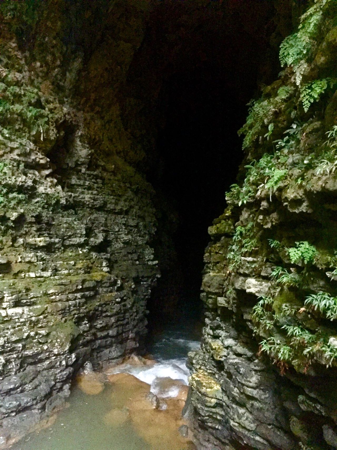 A river leading to a dark cave.