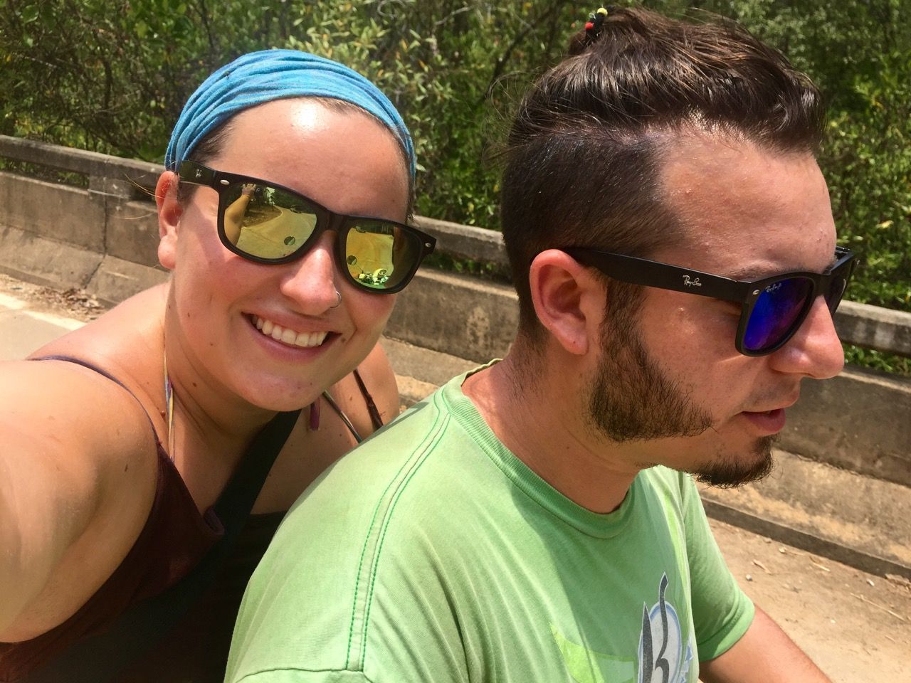 Woman taking photo with man driving a motorbike.