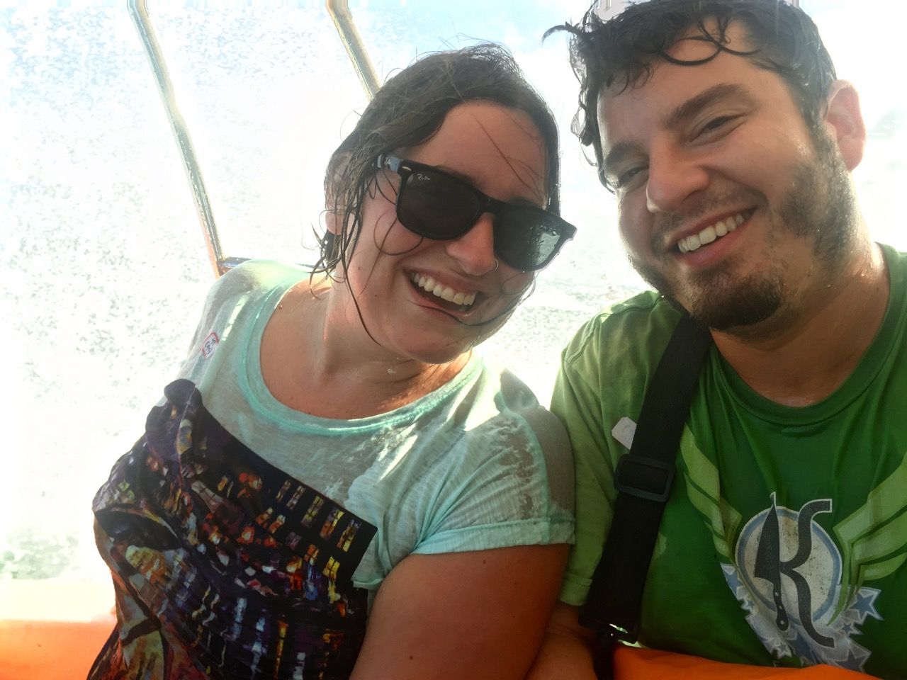 Two people soaked with water and smiling into camera.