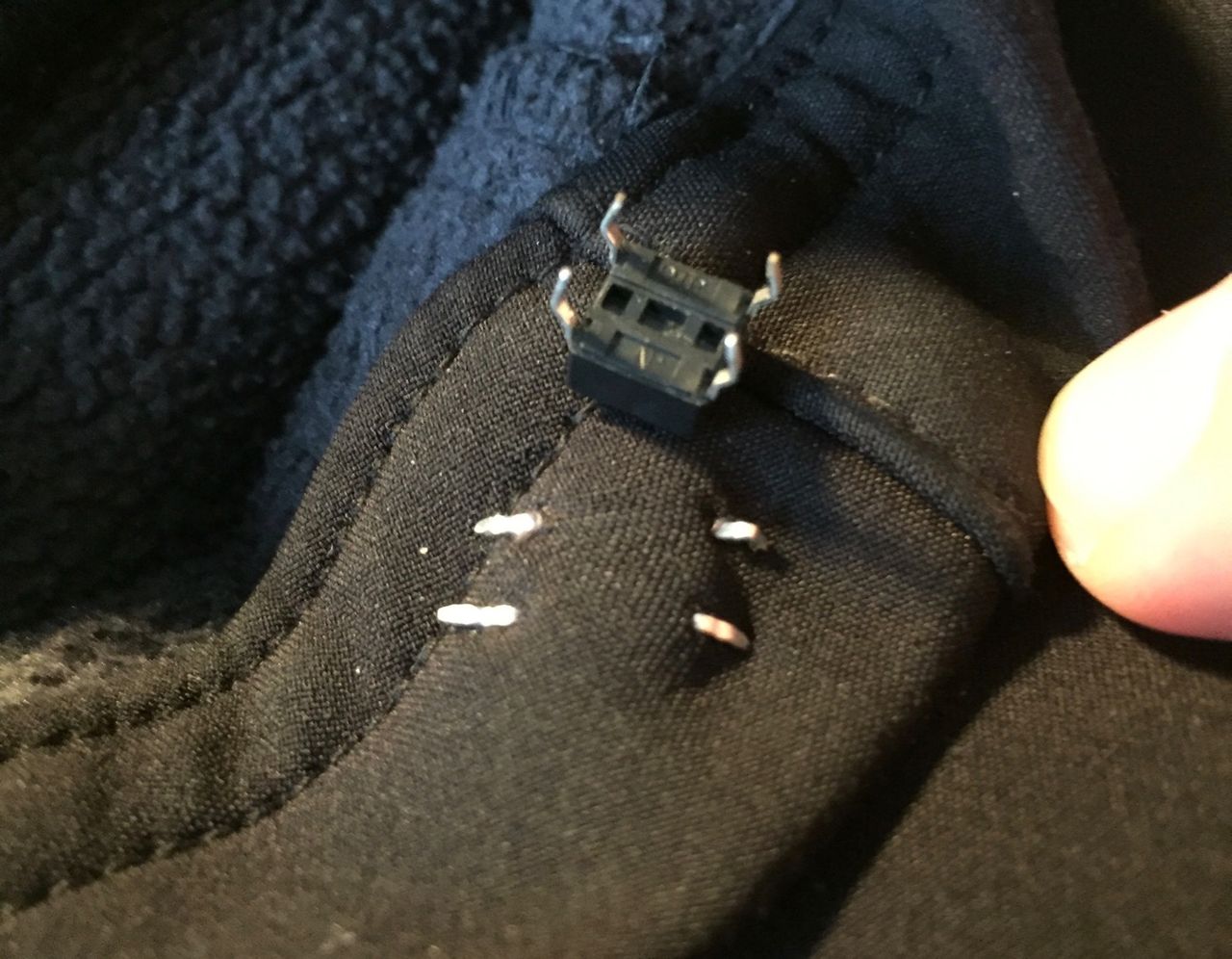 Underside of DIP switch poking through jacket material.