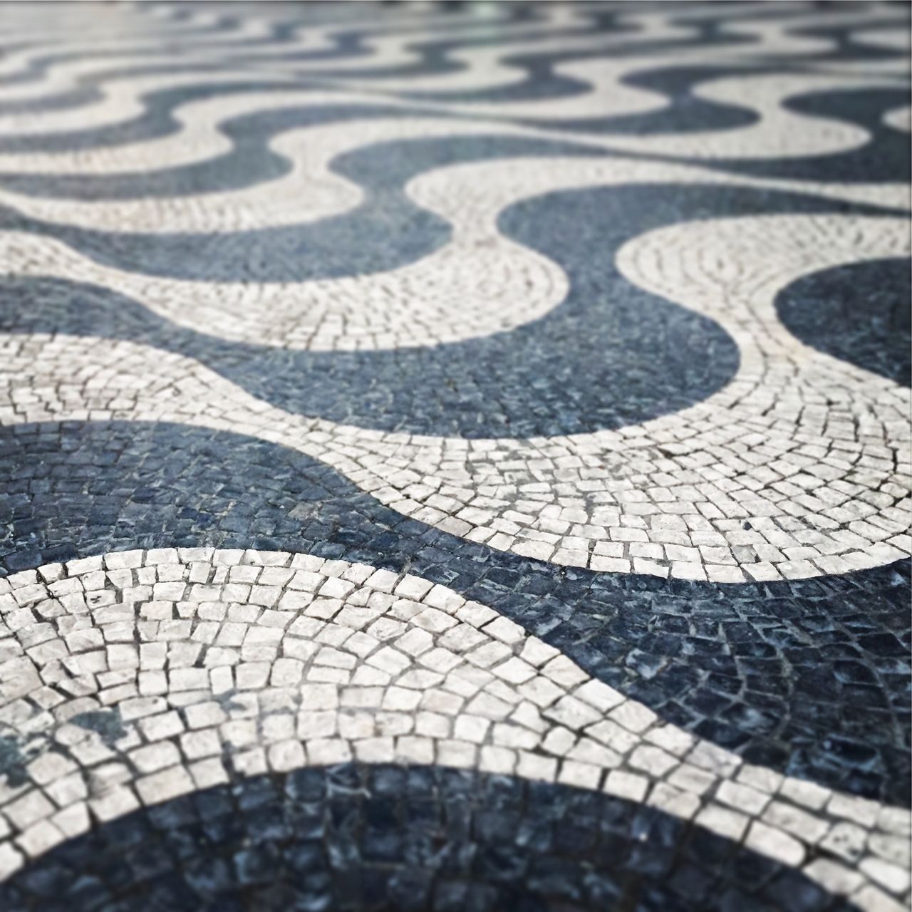 Detailed, patterned stone work in a city square.