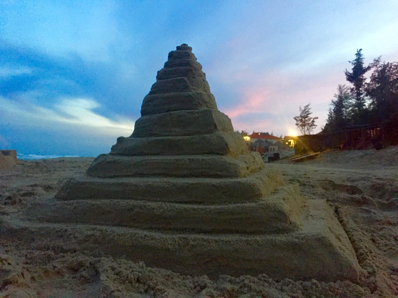 Sandcastle with sunset in the background.