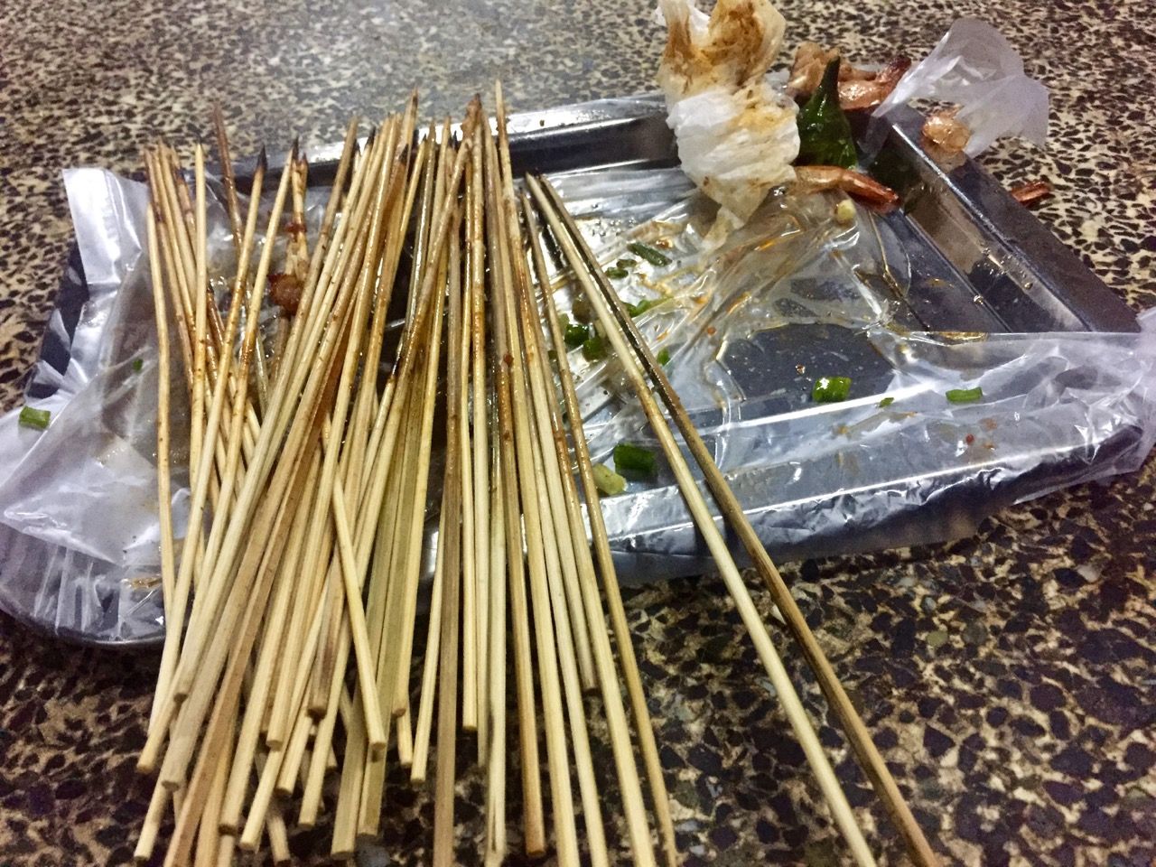 Empty, used skewers on a tray.