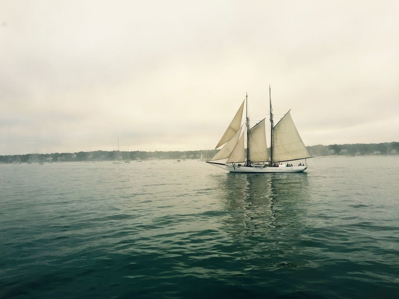 Sailboat on foggy waters.