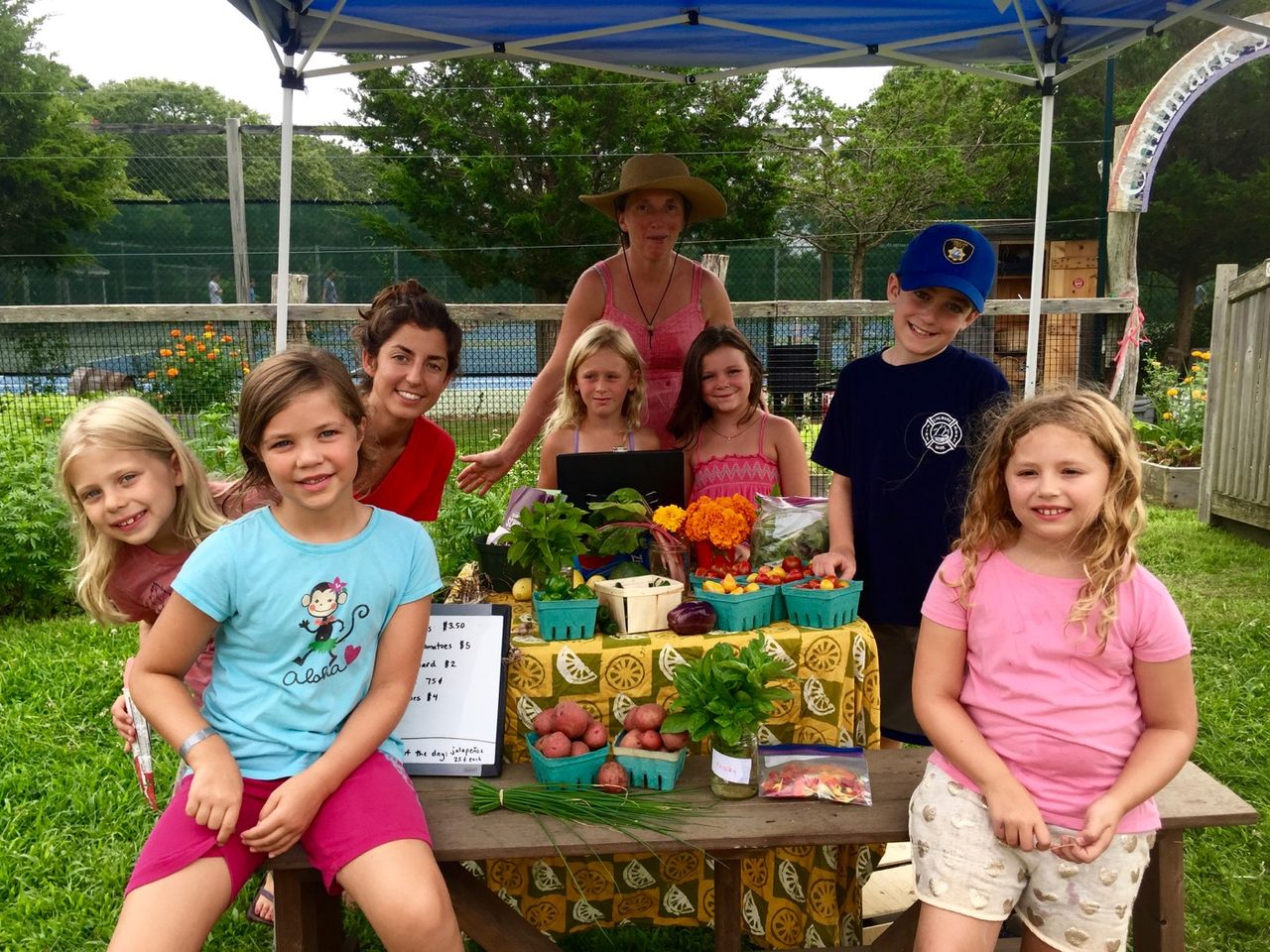 Group photo of kids working at Chillmark Elementary farm stand.