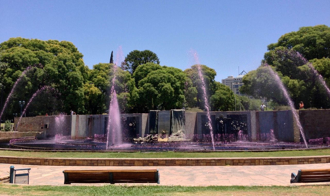 A fountain with pink water.