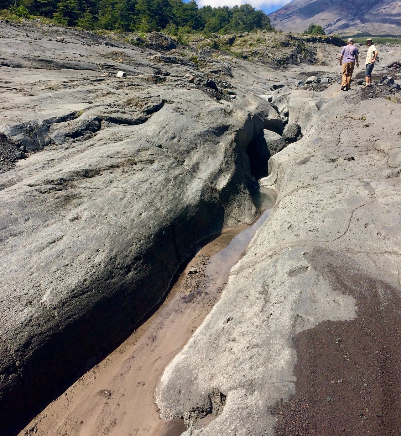 Deep crevice in rocks from water erosion.