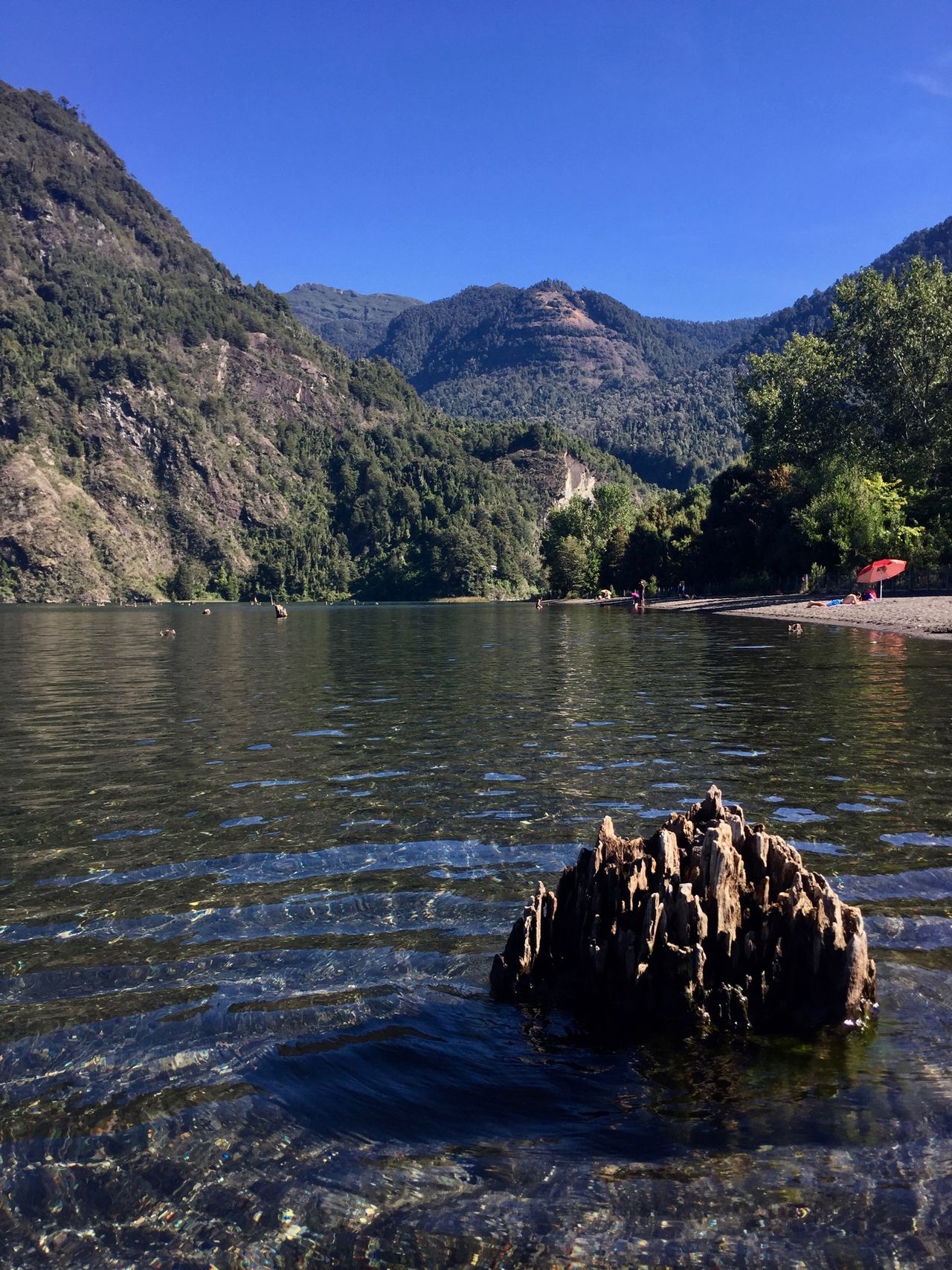 Photo taken from the water looking up at a mountain that resembles an ape.