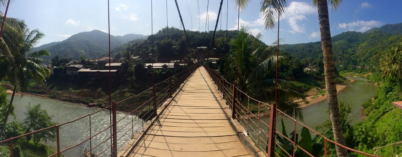 Panoramic from a suspension bridge over a river.