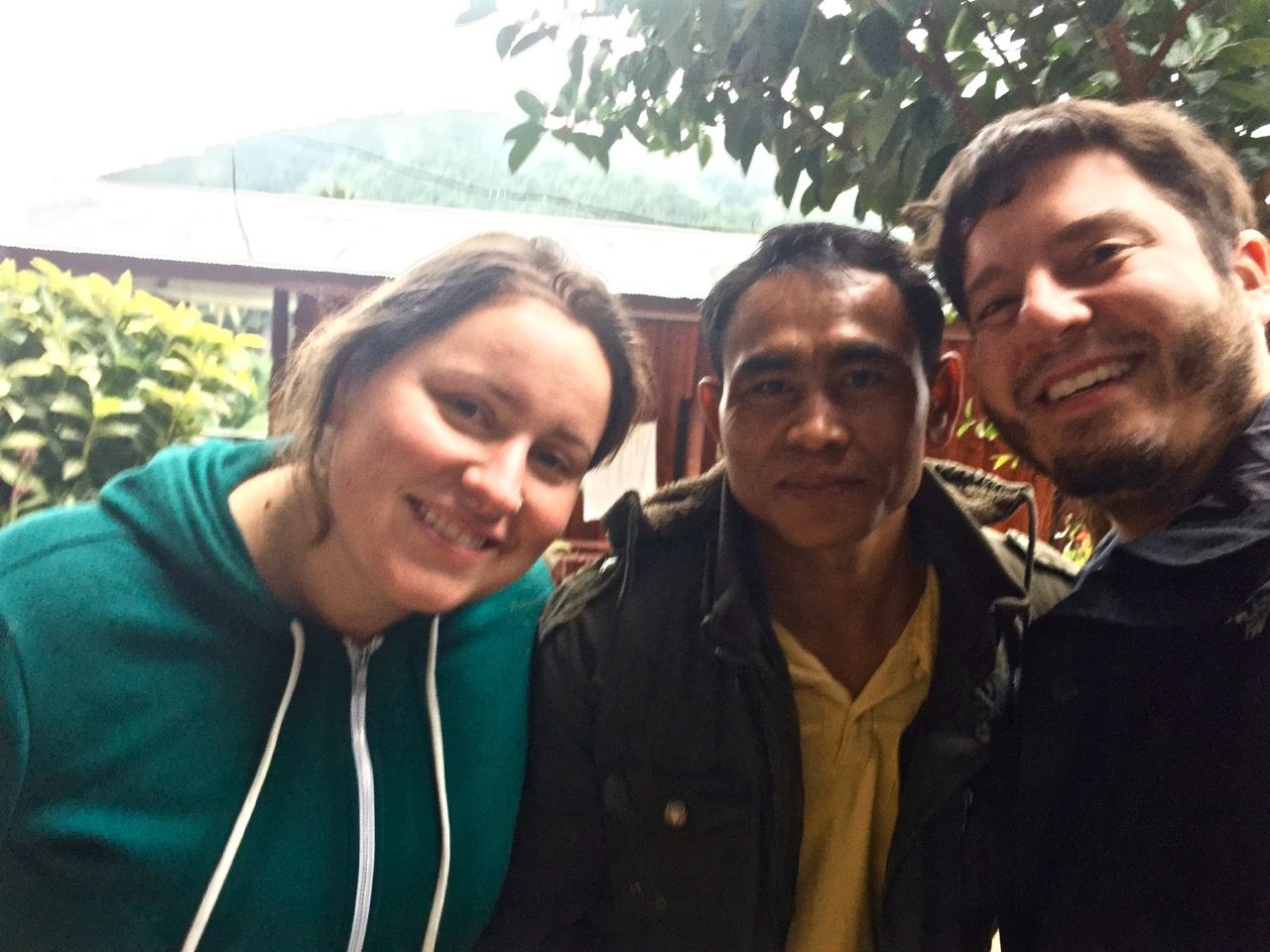Three people smiling into camera.