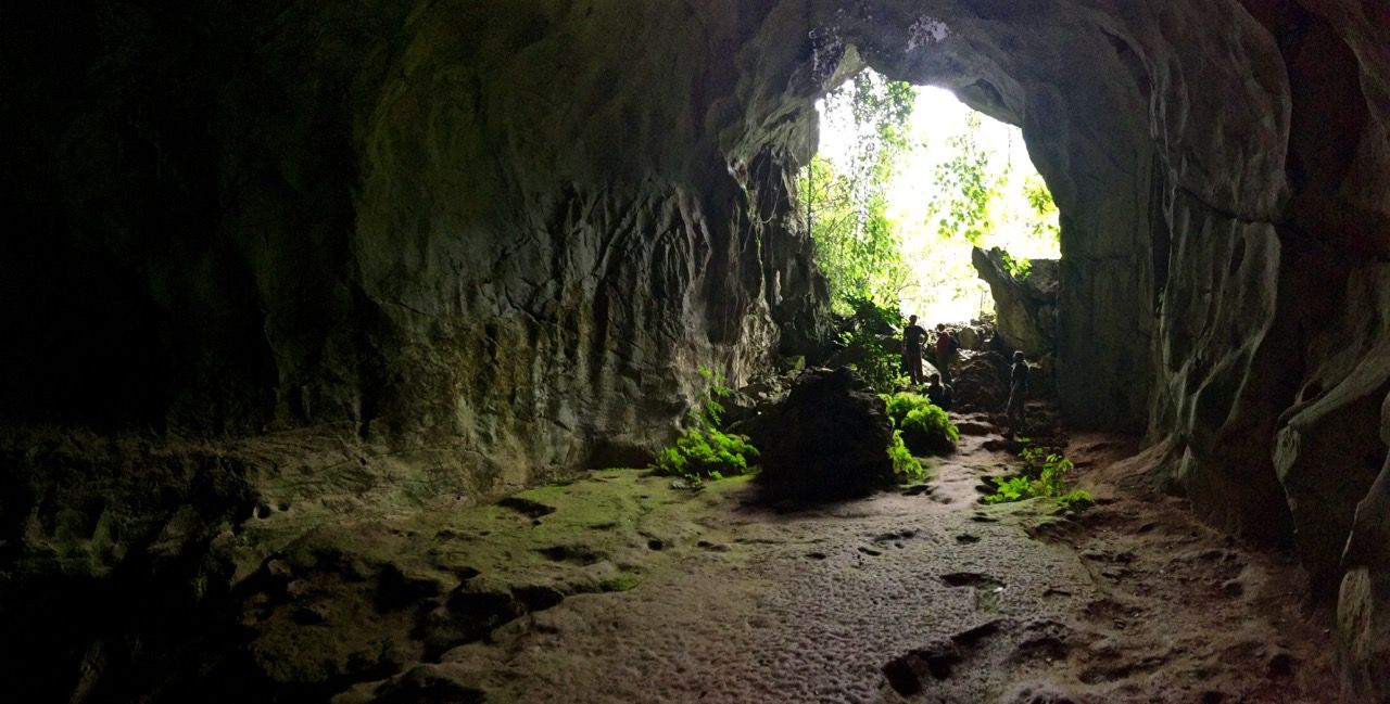 Panoramic of a dimly-lit cave.