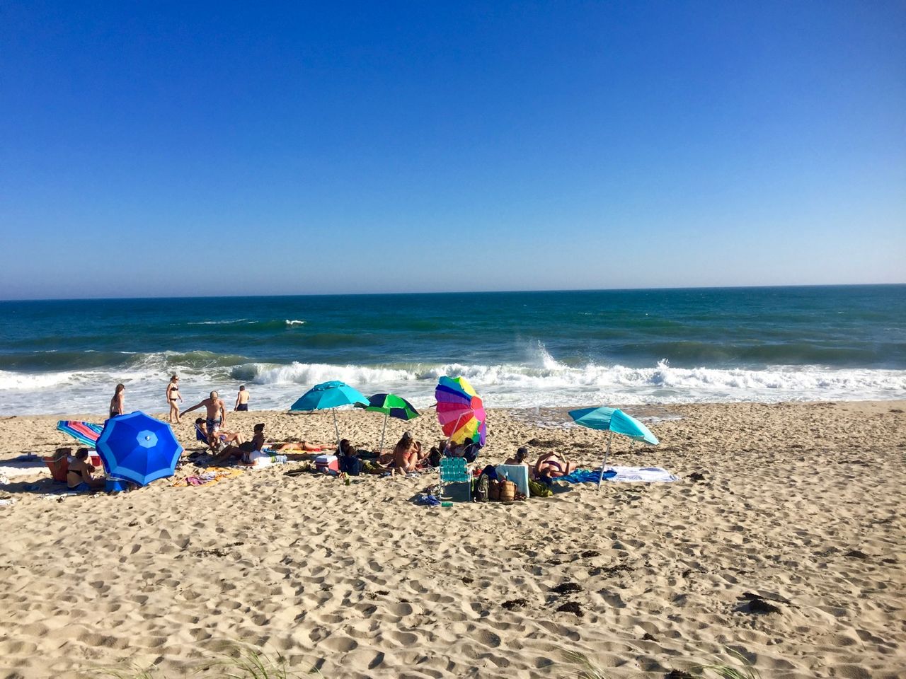 A group of people sprawled out on the beach.