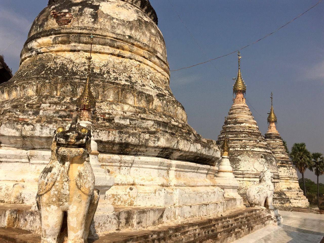 Three white stupas in a row.