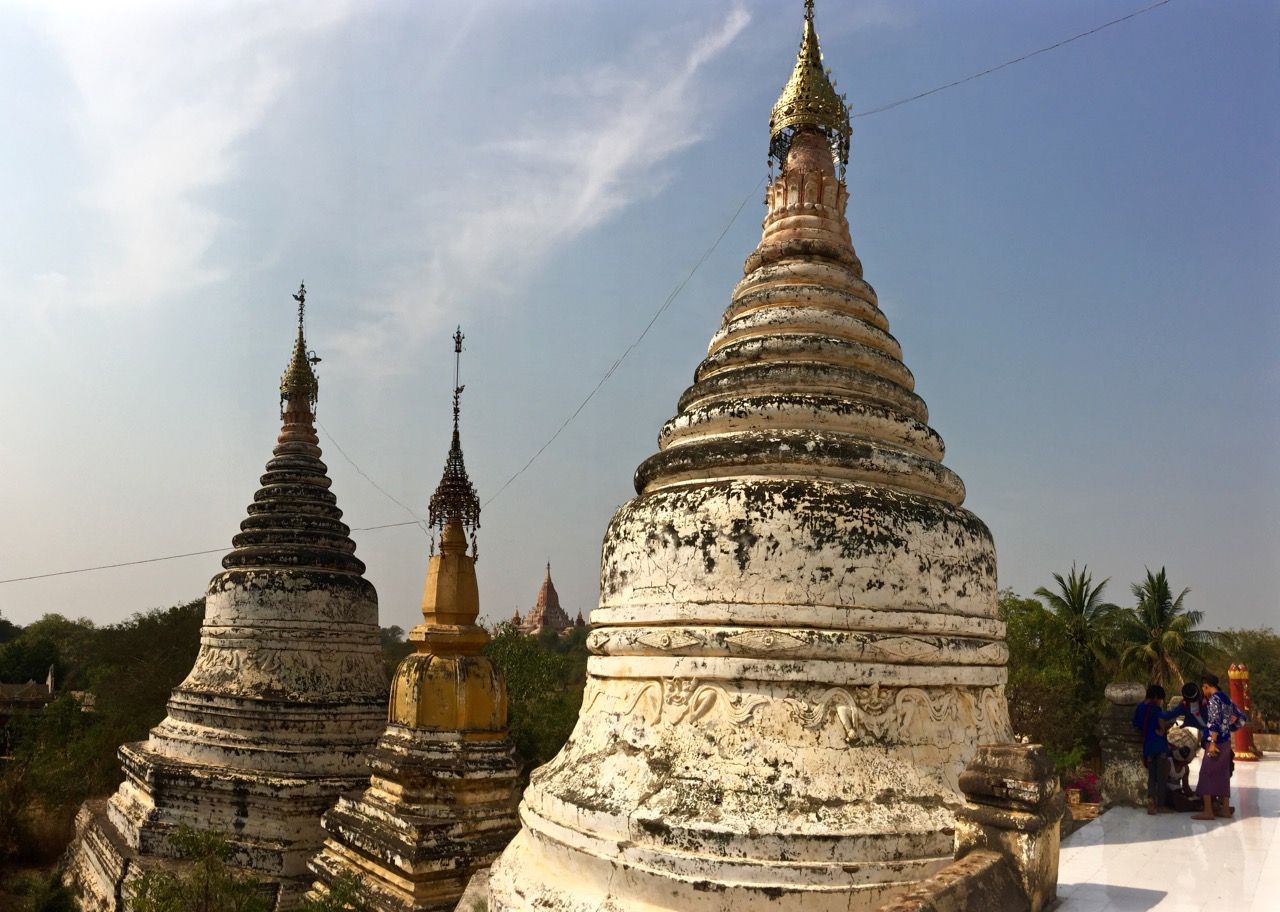 White stupas with golden peaks.
