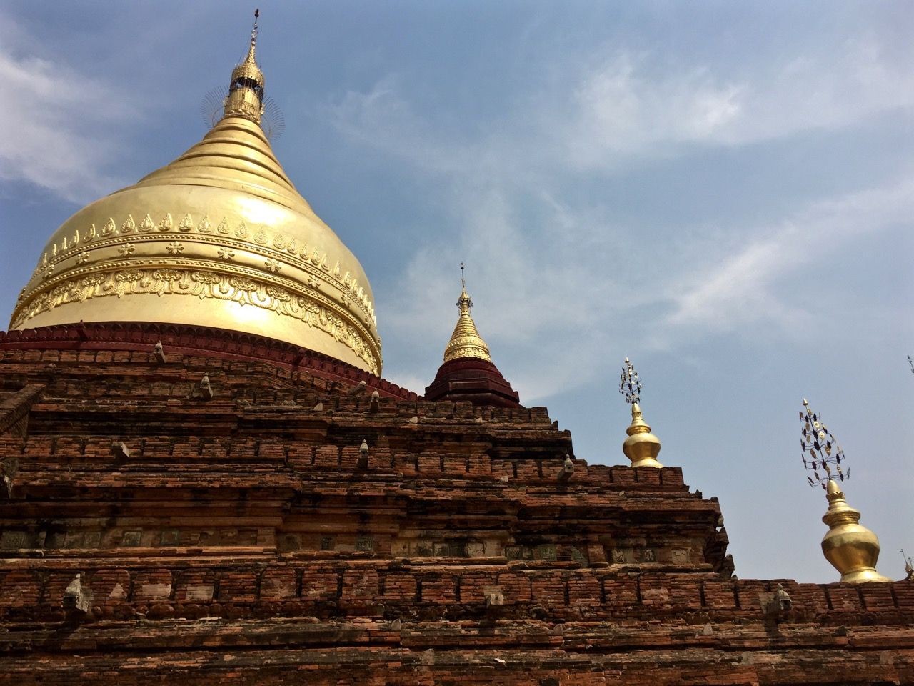 A row of increasingly large golden stupas.
