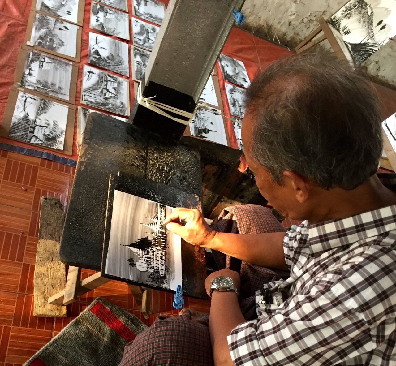Man drawing cards of well-known landscapes in Myanmar.