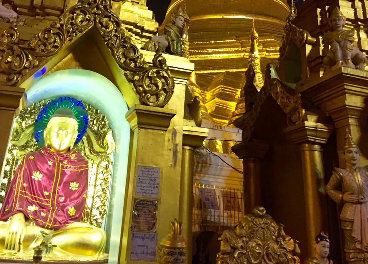 Back-lit golden Buddha statue with LED halo.