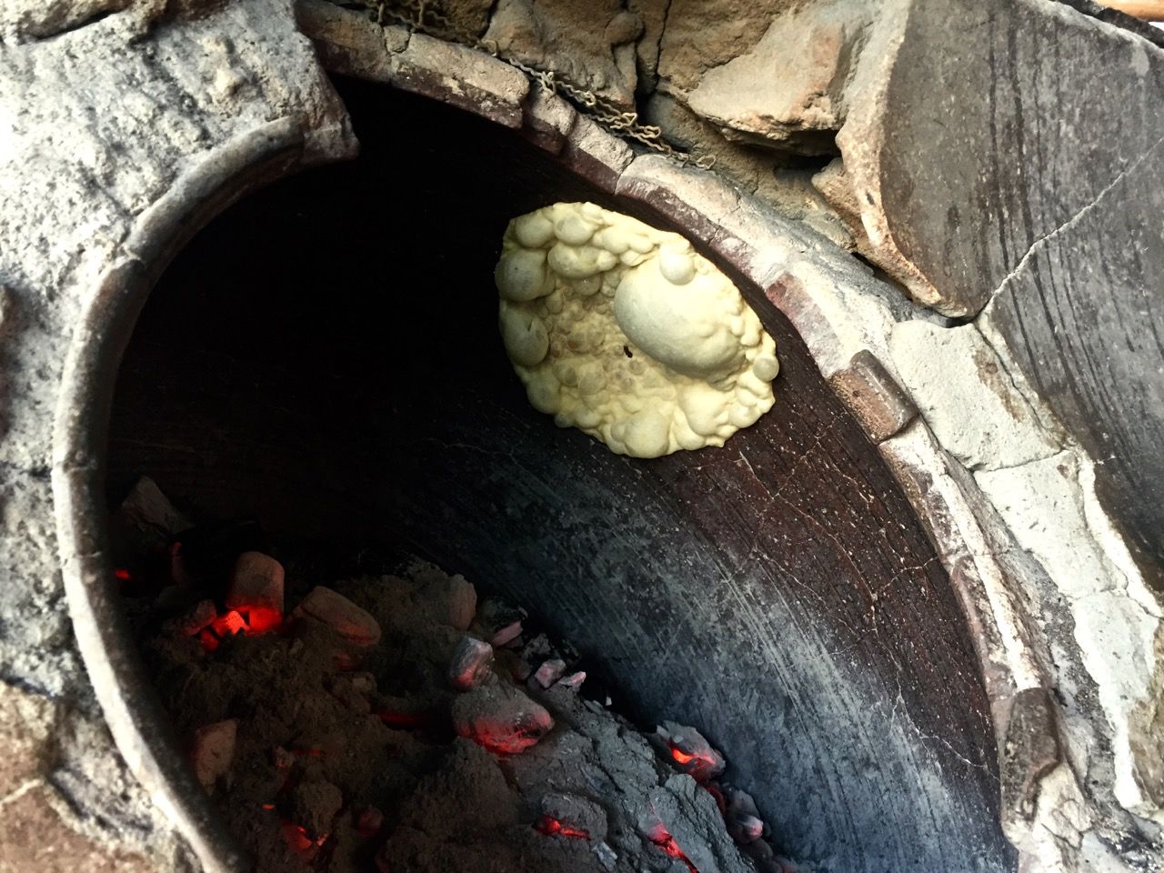 Naan being baked inside an oven.