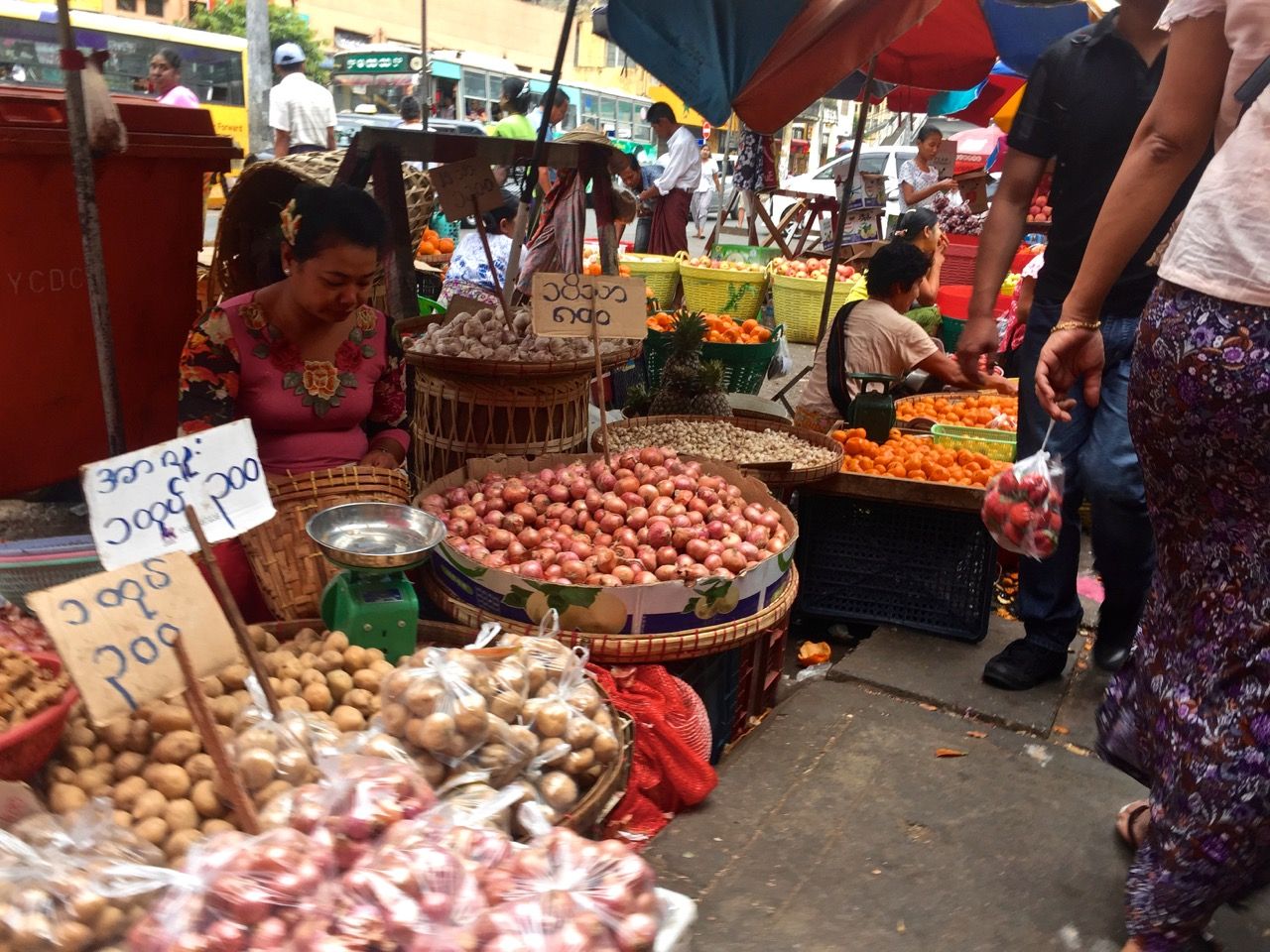 Woman selling various vegetables.