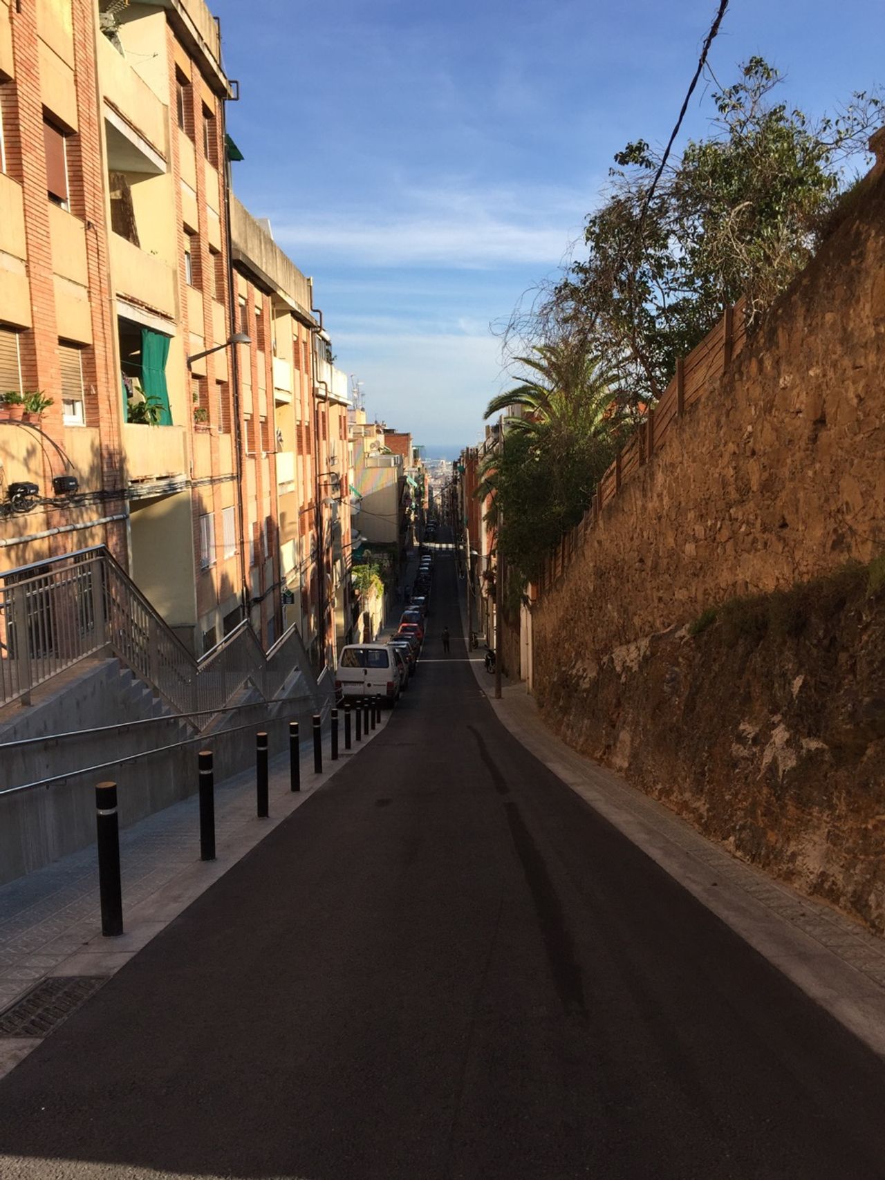 A steep downhill road in the city.