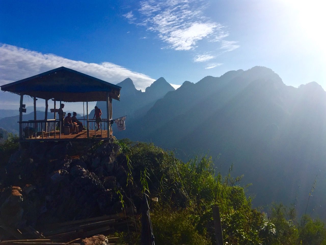 People resting inside a hut at the top of the mountain.