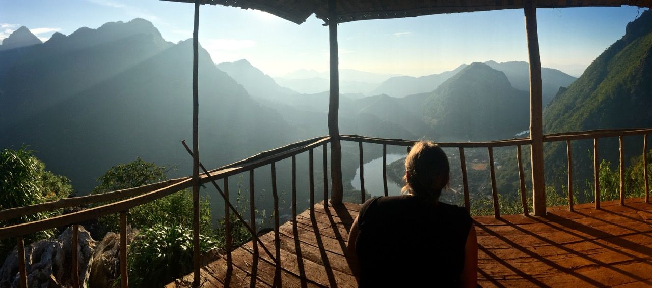 Woman looking down from the mountaintop.