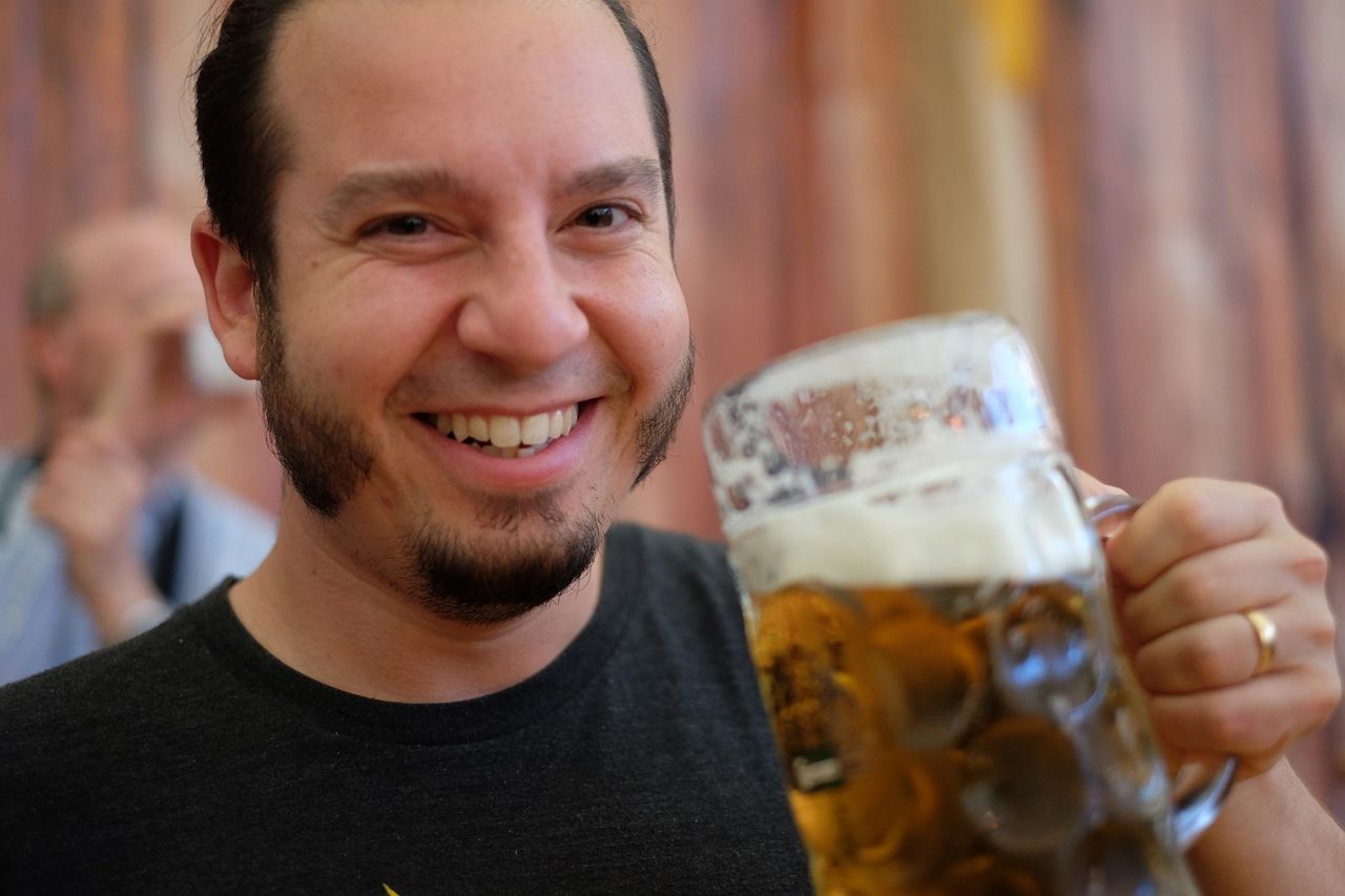 Man smiling with a beer in hand.