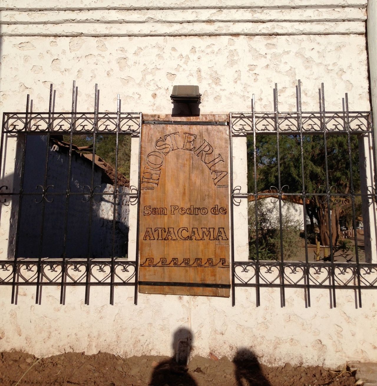 Carved wooden door with the words "Hosteria San Pedro de Atacama"