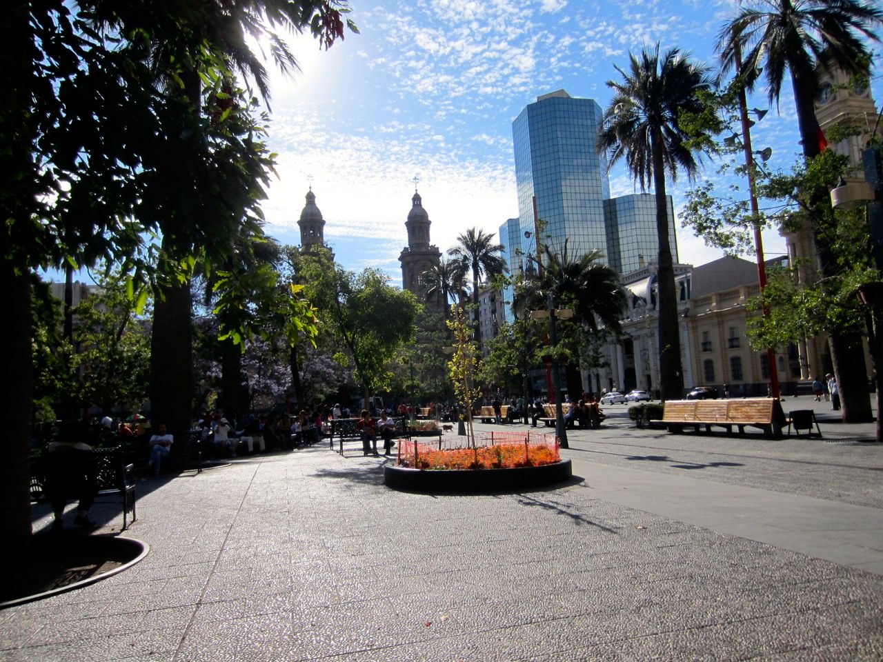 A city square with buildings in the background.