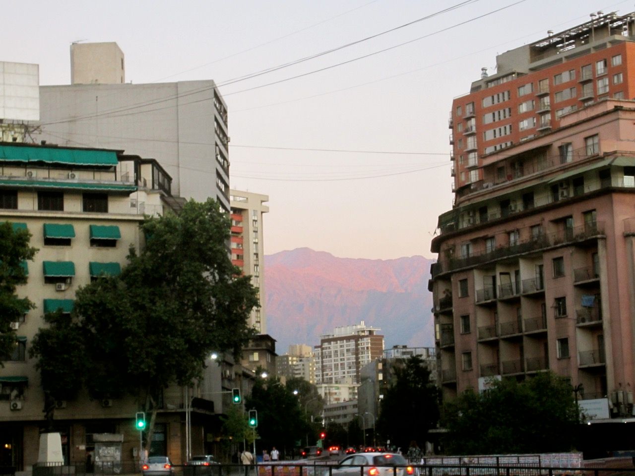 Mountains visible from downtown Santiago, bright red from the sunset.