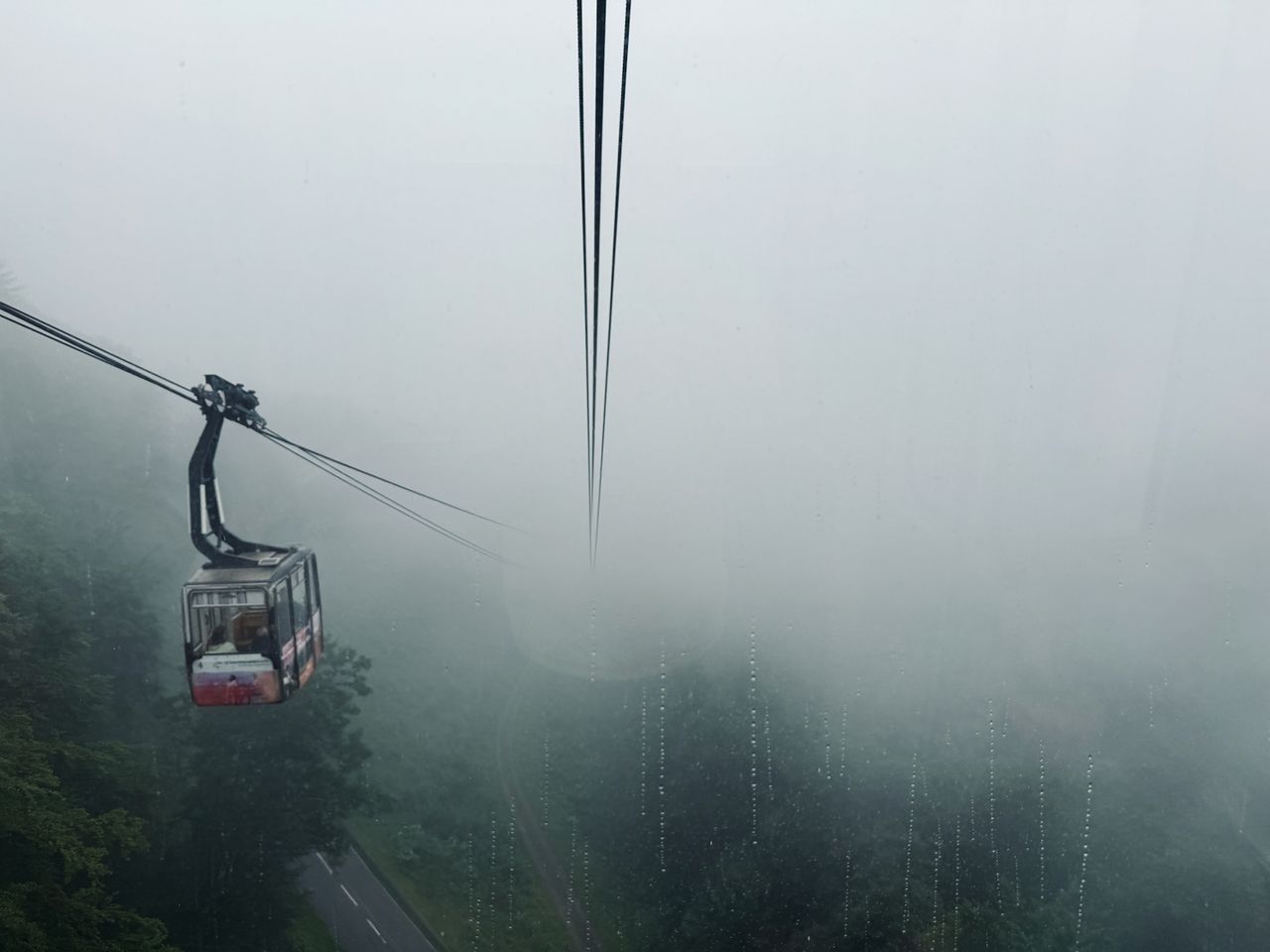 Looking down the gondola line from within a thick fog